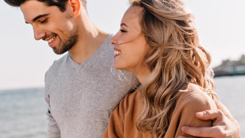 inspired-young-man-embracing-girlfriend-walk-beach-curious-blonde-woman-spending-weekend-sea1